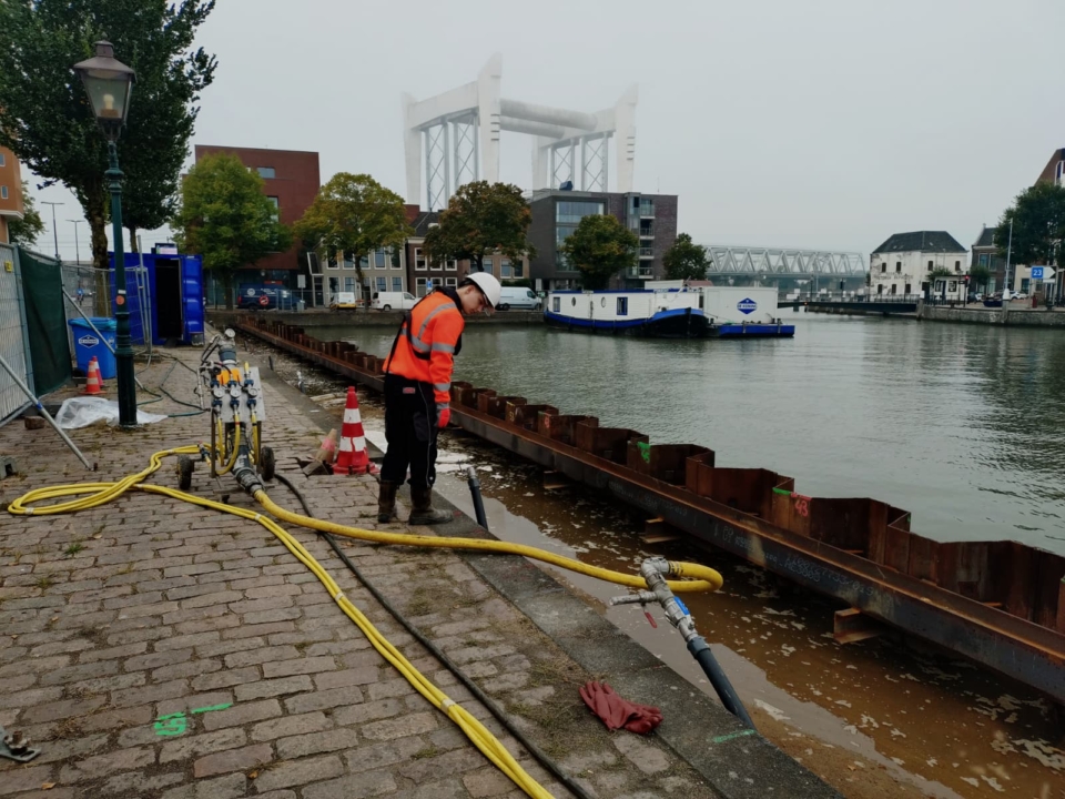 The hose is connected at points along the quay wall.